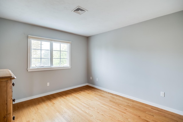 unfurnished room featuring wood finished floors and baseboards