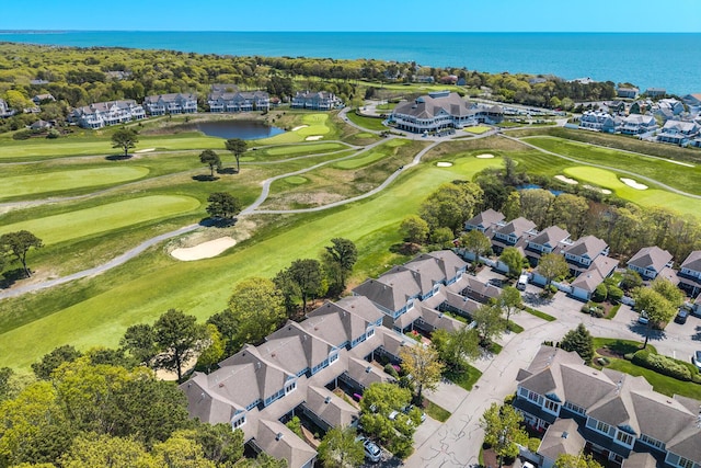 aerial view of residential area with a large body of water and a local golf course