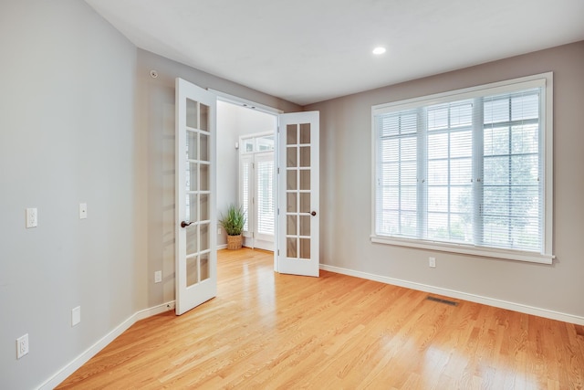 unfurnished room with french doors, wood finished floors, baseboards, and recessed lighting