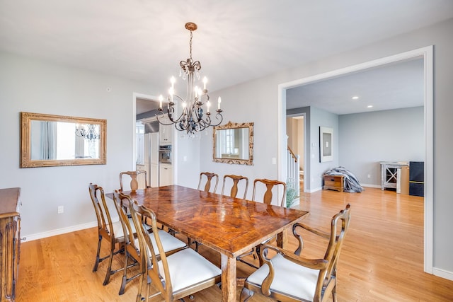 dining room with light wood-style floors, baseboards, a chandelier, recessed lighting, and stairway