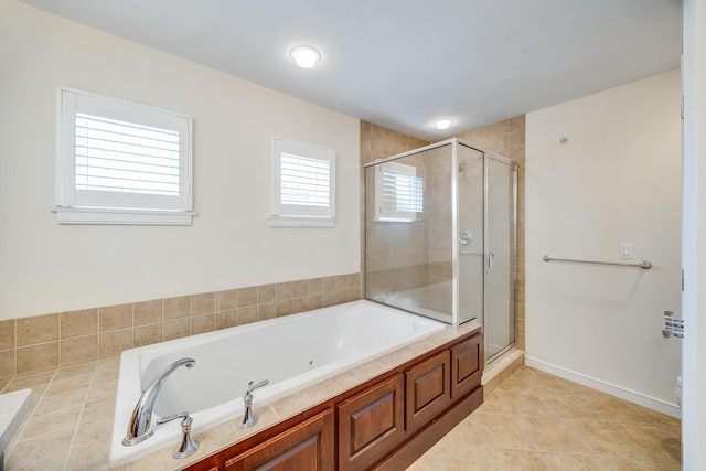 bathroom featuring a stall shower, a bath, and tile patterned floors