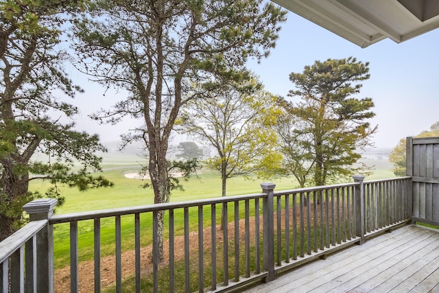 wooden deck with a lawn
