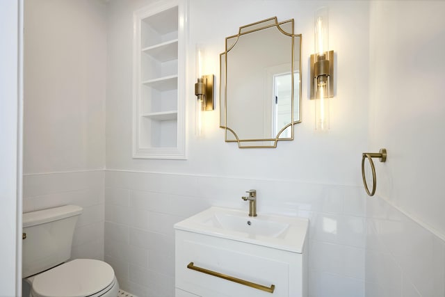 401 Main St Unit 201, West Dennis, MA 02670 - half bath with tile walls, a wainscoted wall, toilet, and vanity