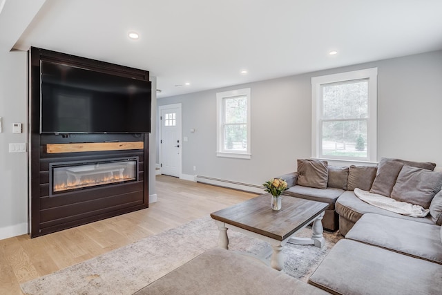 115 Kiahs Way E, Sandwich, MA 02537 - living room with a baseboard radiator, light wood-type flooring, a large fireplace, recessed lighting, and baseboards