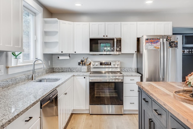 115 Kiahs Way E, Sandwich, MA 02537 - kitchen featuring appliances with stainless steel finishes, a sink, white cabinetry, light stone counters, and recessed lighting