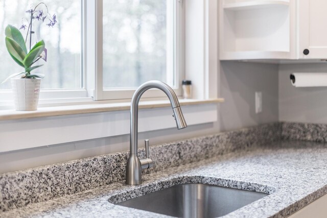 115 Kiahs Way E, Sandwich, MA 02537 - kitchen view of a sink, white cabinets, and light stone countertops
