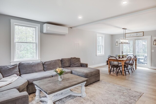 115 Kiahs Way E, Sandwich, MA 02537 - living area with a wall mounted AC, baseboards, light wood-type flooring, and recessed lighting