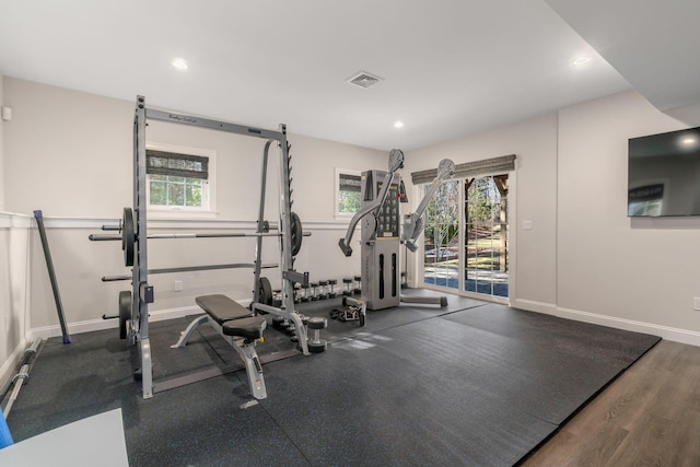 exercise room with recessed lighting, visible vents, and baseboards