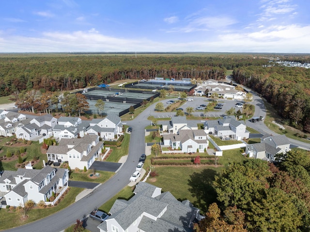 birds eye view of property featuring a forest view and a residential view