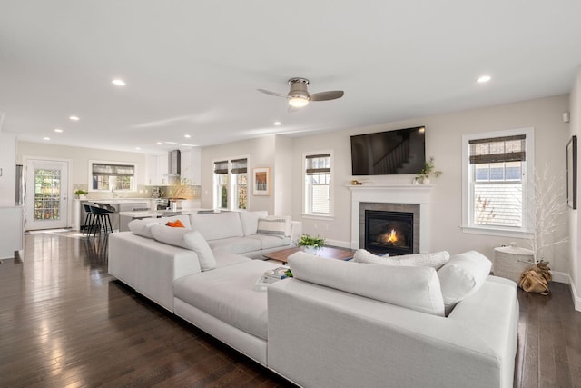 living room with dark wood finished floors, plenty of natural light, and recessed lighting