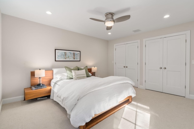 bedroom with carpet, baseboards, multiple closets, and recessed lighting