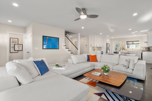 living room with a ceiling fan, recessed lighting, and stairway