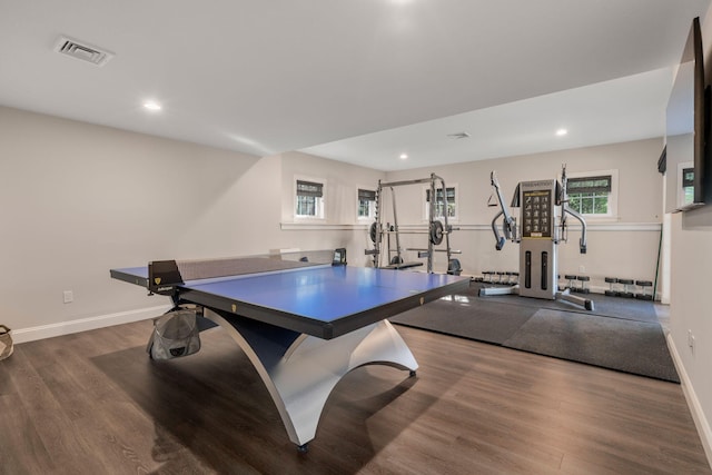 recreation room featuring dark wood-style floors, recessed lighting, visible vents, and baseboards