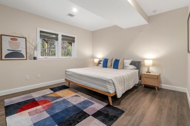 bedroom with dark wood-type flooring, visible vents, and baseboards