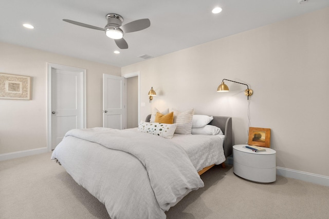 bedroom with ceiling fan, recessed lighting, light colored carpet, visible vents, and baseboards