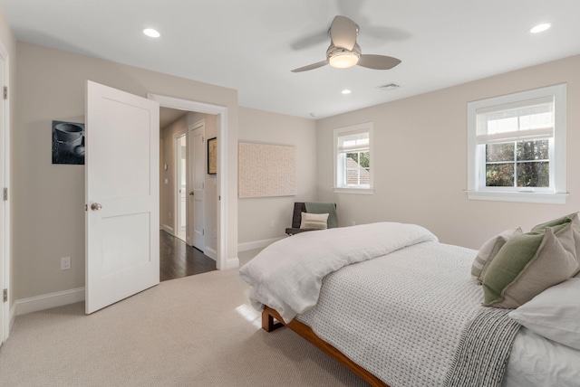 carpeted bedroom featuring baseboards, visible vents, and recessed lighting