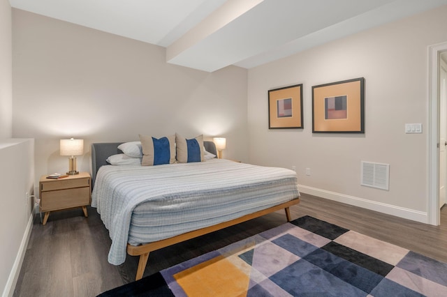 bedroom with visible vents, dark wood finished floors, and baseboards