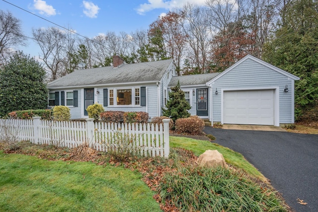 ranch-style home with a garage and a front lawn