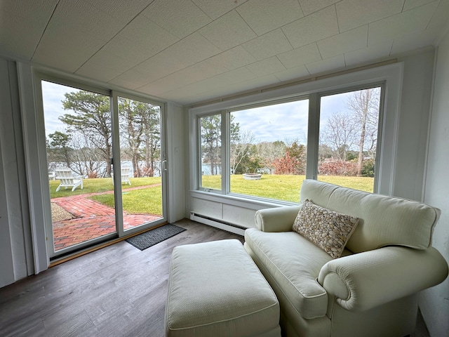 sunroom featuring a baseboard heating unit