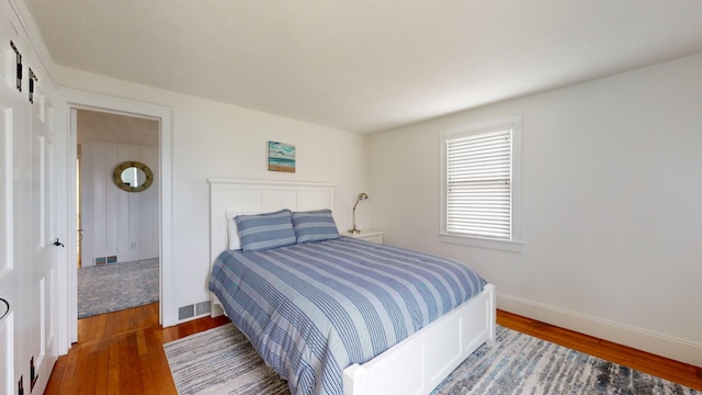 bedroom with dark hardwood / wood-style flooring