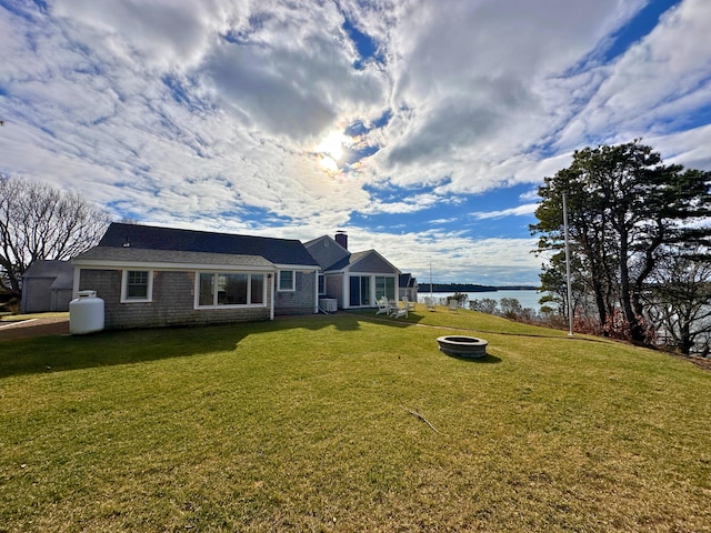 view of front of property featuring central AC and a front lawn