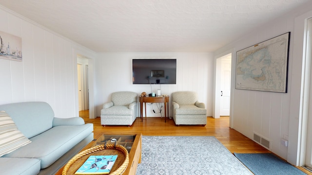 living room featuring hardwood / wood-style flooring and a textured ceiling