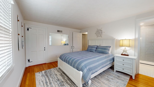 bedroom with wood-type flooring