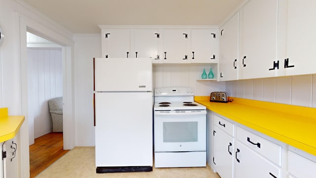 kitchen with white cabinets, backsplash, white appliances, and crown molding