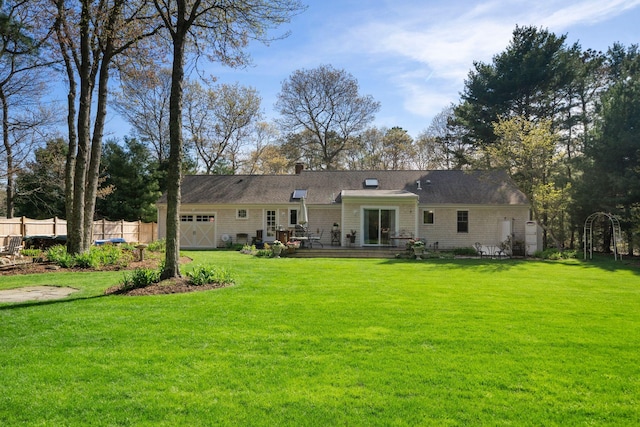 rear view of house featuring an attached garage