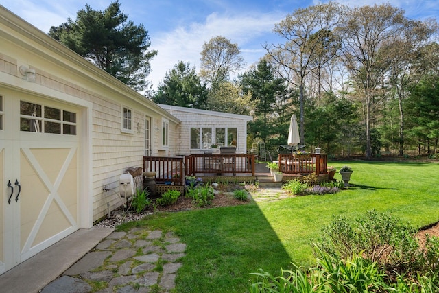 view of grassy yard with a wooden deck