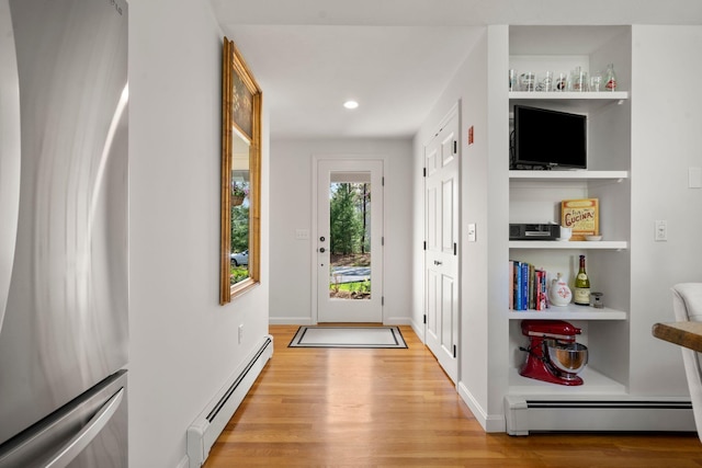 entryway with a baseboard heating unit, light wood-type flooring, recessed lighting, and baseboards