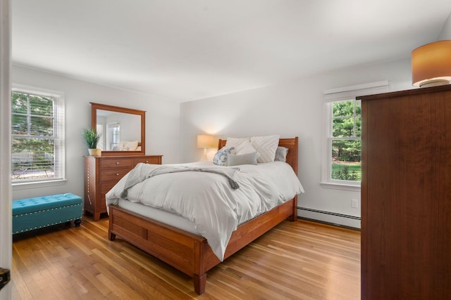 bedroom featuring a baseboard radiator and light wood finished floors