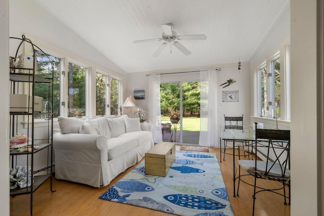 sunroom / solarium with healthy amount of natural light, wood finished floors, french doors, and lofted ceiling