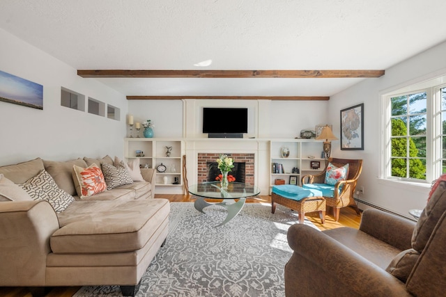 living room with beamed ceiling, wood finished floors, baseboard heating, and a brick fireplace