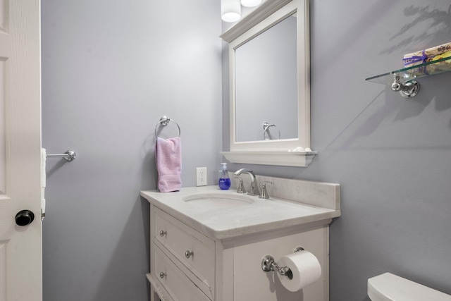 bathroom with toilet and vanity