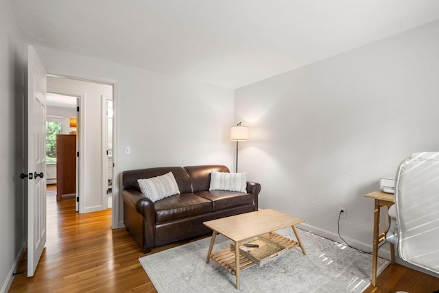 living area with wood finished floors and baseboards