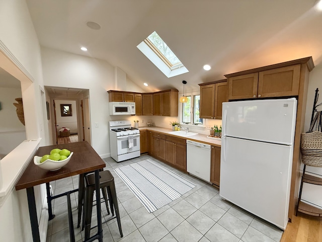 4 Frank Doyle Rd, South Dennis, MA 02660 - kitchen with white appliances, a sink, a skylight, lofted ceiling, and light countertops