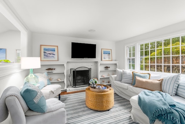 4 Frank Doyle Rd, South Dennis, MA 02660 - living area with wood finished floors and a brick fireplace