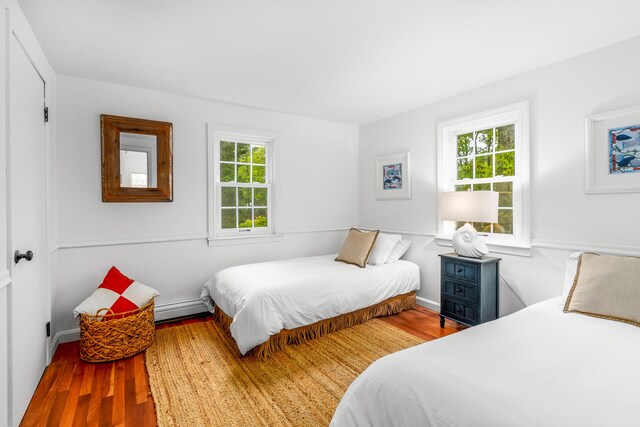 4 Frank Doyle Rd, South Dennis, MA 02660 - bedroom with wood finished floors, a baseboard heating unit, and baseboards