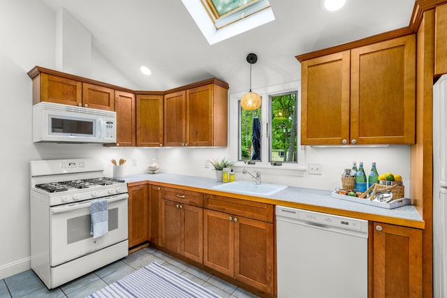 4 Frank Doyle Rd, South Dennis, MA 02660 - kitchen with white appliances, a sink, a skylight, light countertops, and brown cabinetry