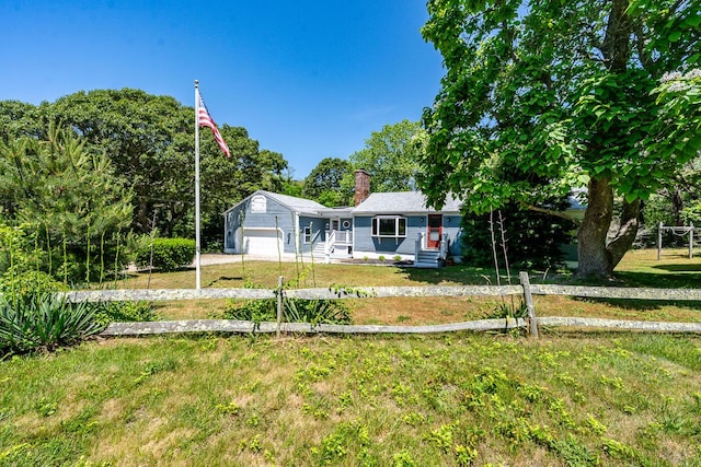 2 Pine Ridge End, Truro, MA 02666 - view of front facade with a chimney, a front lawn, and an attached garage