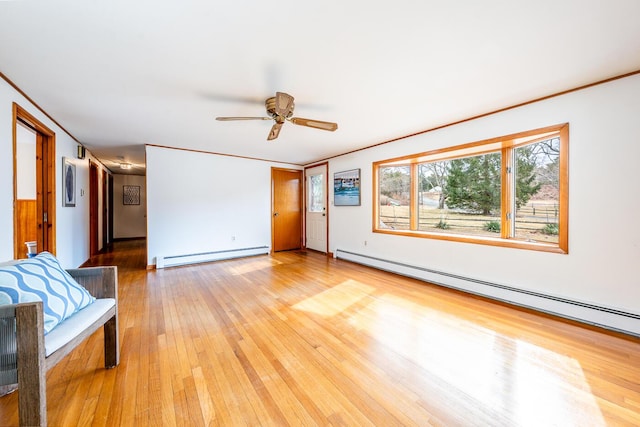 unfurnished living room with light wood finished floors, baseboard heating, a baseboard heating unit, ornamental molding, and a ceiling fan