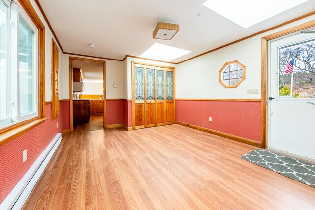 2 Pine Ridge End, Truro, MA 02666 - foyer featuring a skylight, baseboard heating, light wood-style flooring, healthy amount of natural light, and a wainscoted wall