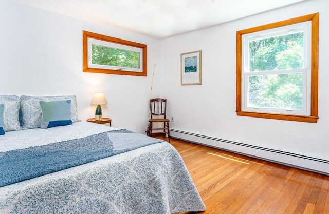 2 Pine Ridge End, Truro, MA 02666 - bedroom featuring baseboard heating, multiple windows, and wood finished floors