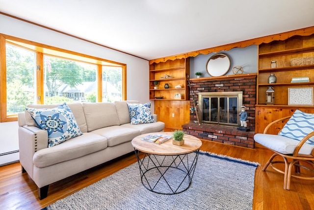 2 Pine Ridge End, Truro, MA 02666 - living area with healthy amount of natural light, wood finished floors, a brick fireplace, and built in shelves