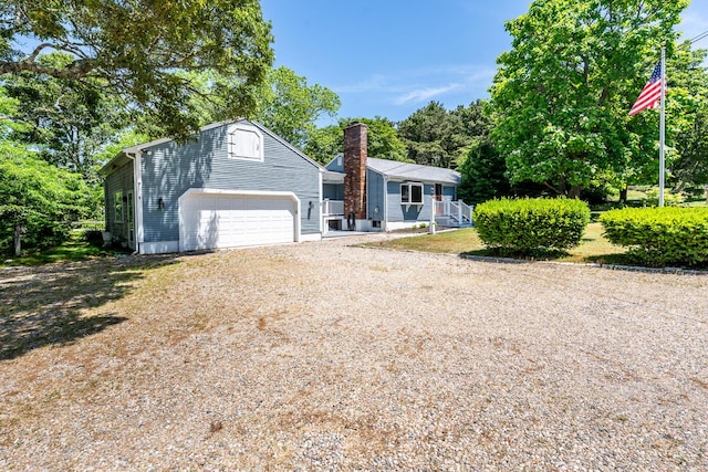 2 Pine Ridge End, Truro, MA 02666 - view of front of home with driveway, an attached garage, and a chimney