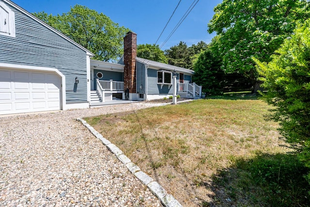 2 Pine Ridge End, Truro, MA 02666 - rear view of property featuring a chimney, a garage, a yard, and covered porch