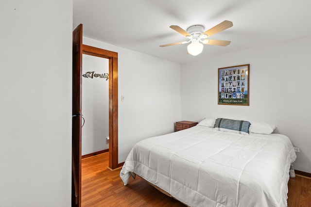 bedroom with hardwood / wood-style flooring and ceiling fan