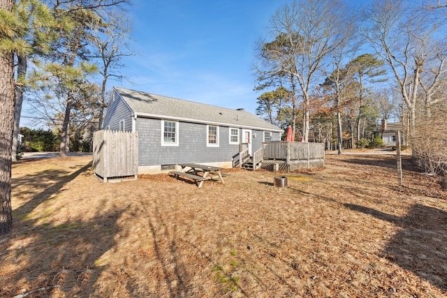 back of property with a wooden deck