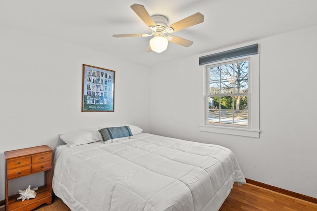 bedroom with hardwood / wood-style flooring and ceiling fan